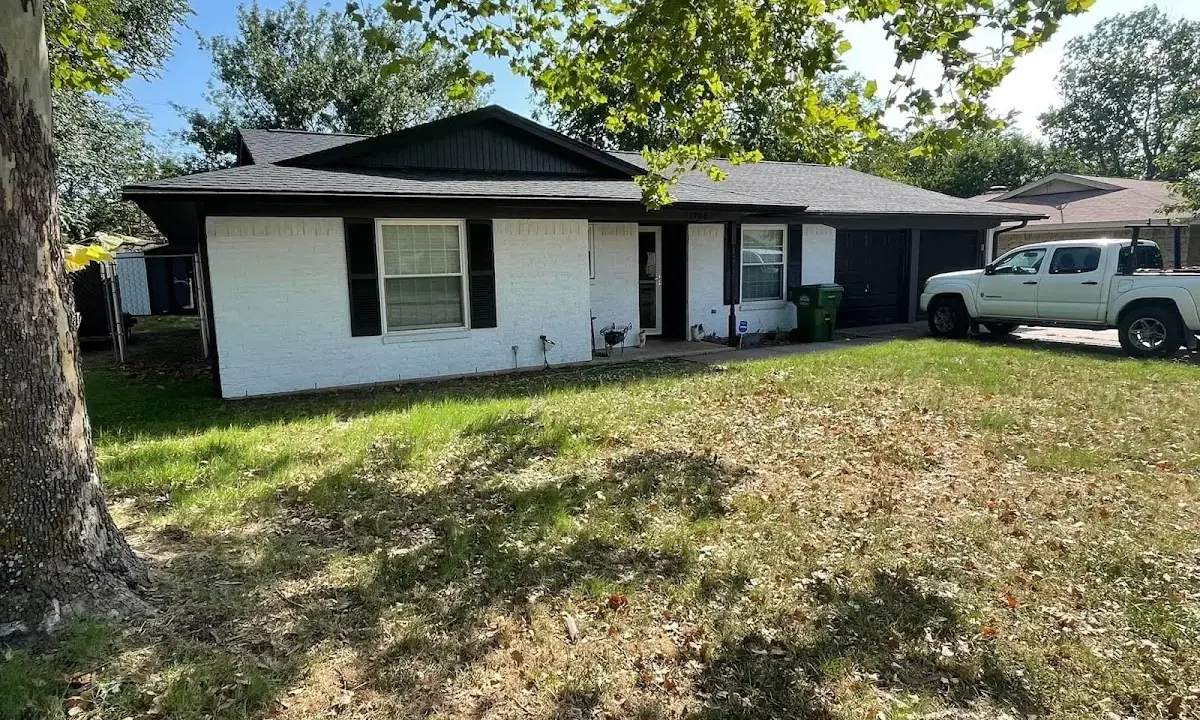 Professional roofing crew working on a residential roof in Earlimart